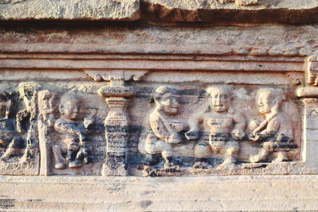 Ancient stone carving at Mahabubnagar Tourist Places showing ritual gathering scene