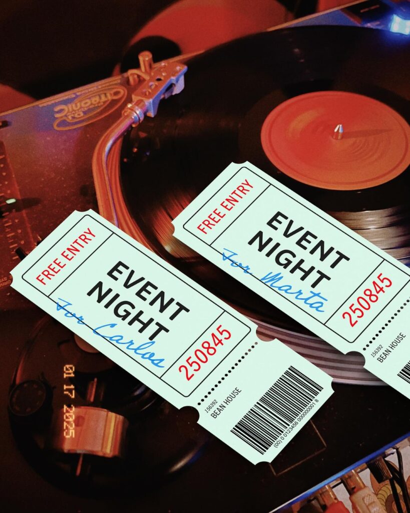event night tickets placed on a DJ turntable with vinyl record